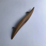 Elegant teak door handle by Wood Ceylon featuring a smooth, curved design for modern interiors