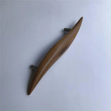 Elegant teak door handle by Wood Ceylon featuring a smooth, curved design for modern interiors
