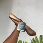 Wood Ceylon handcrafted wooden front door handle hardware with natural finish held against white wall