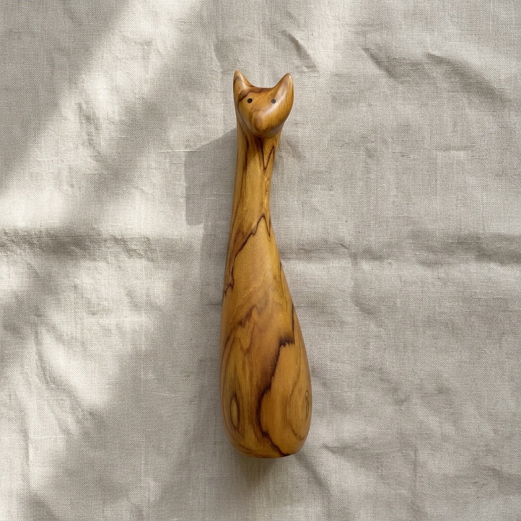 Close-up of teak cat sculpture head and carved detail