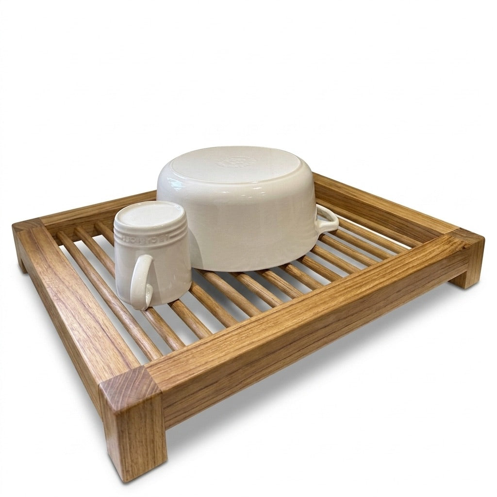 Teak drying rack in natural finish holding white dishes