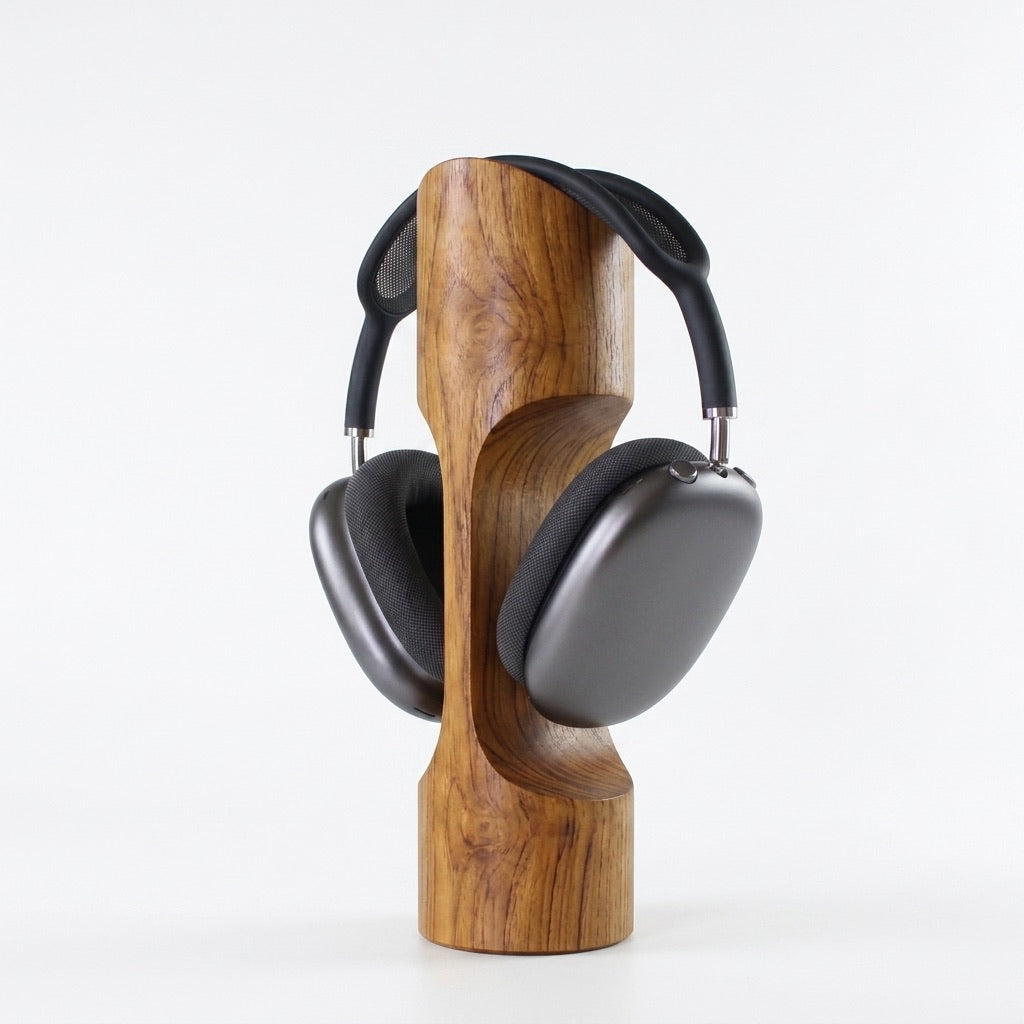 Wooden headphone stand holding a pair of gray headphones on a white background