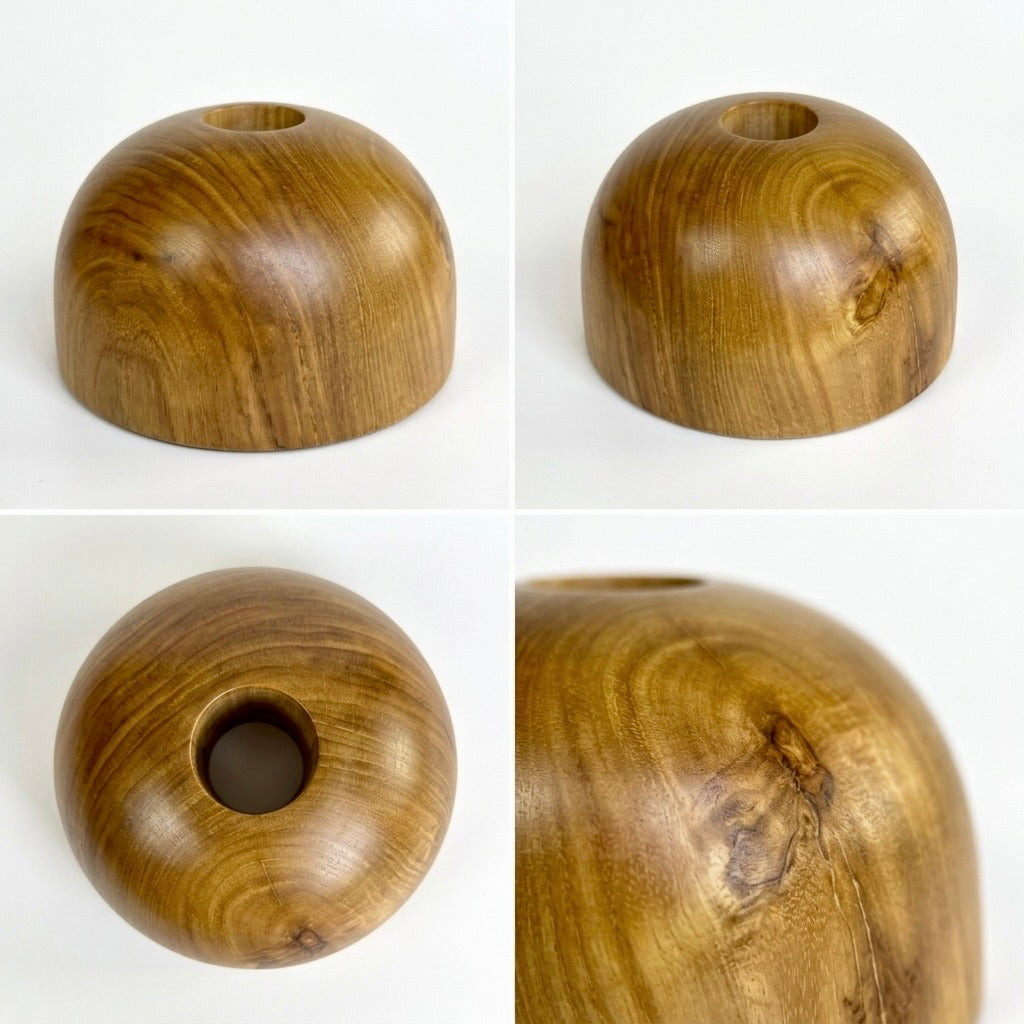 Close-up of teak dome vase showing smooth rounded wood shape
