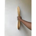 Hand holding a wooden closet door handle with a sleek design against a white background