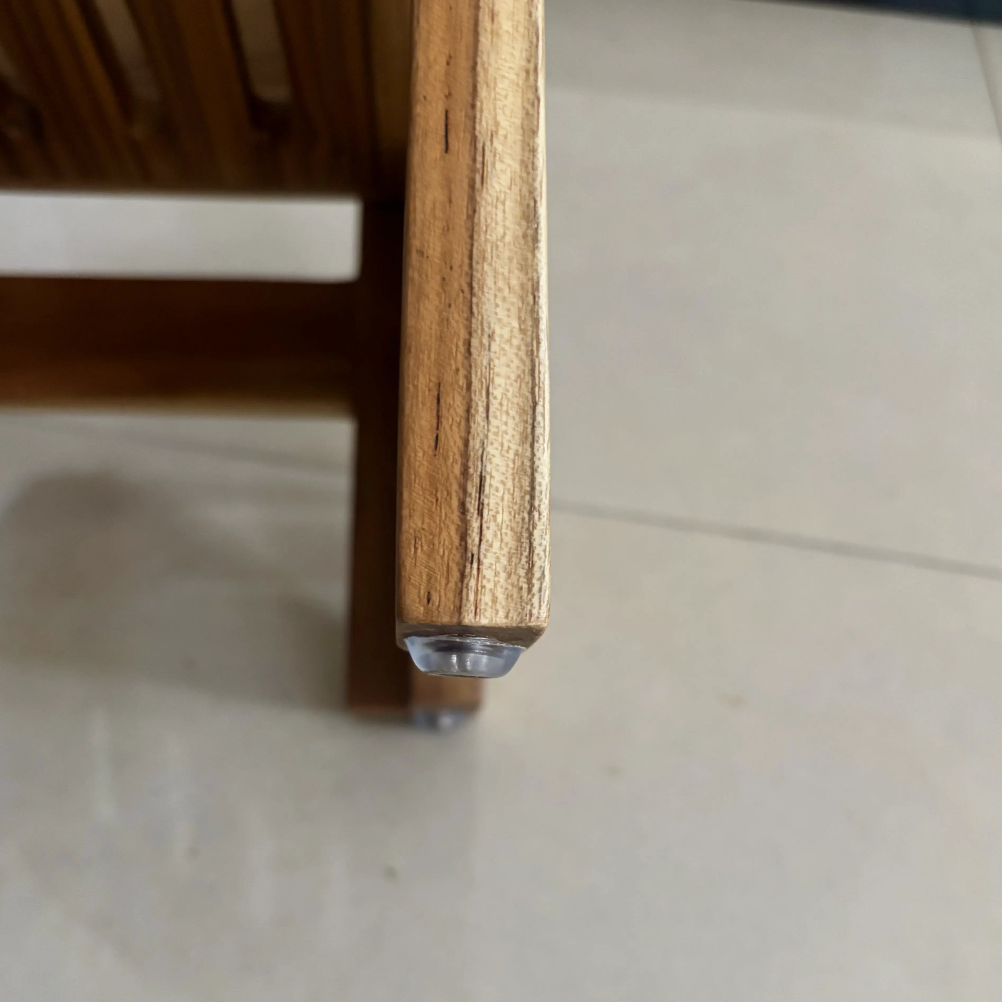 Close-up of a wooden corner shelf edge showcasing the fine craftsmanship and natural finish