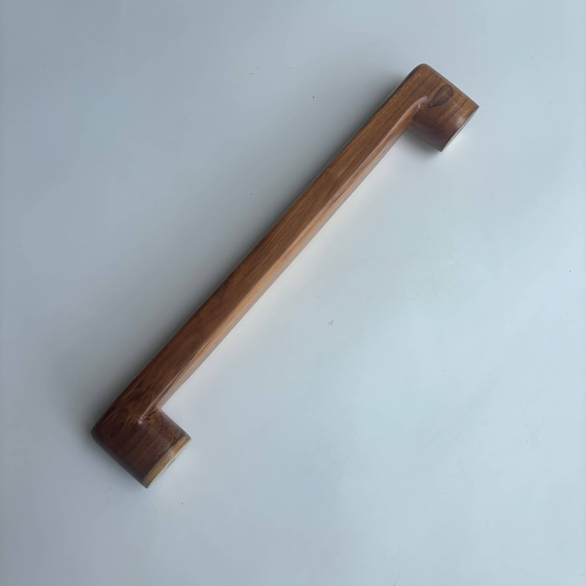 Teak wood door handles in natural finish for stylish entryways