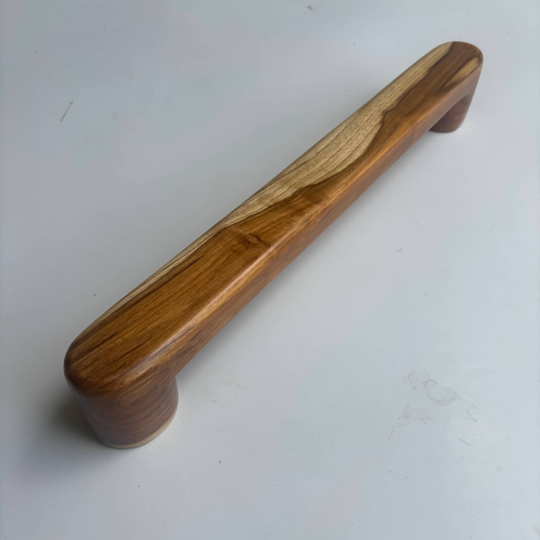Teak wood door handle with a natural finish for a stylish touch
