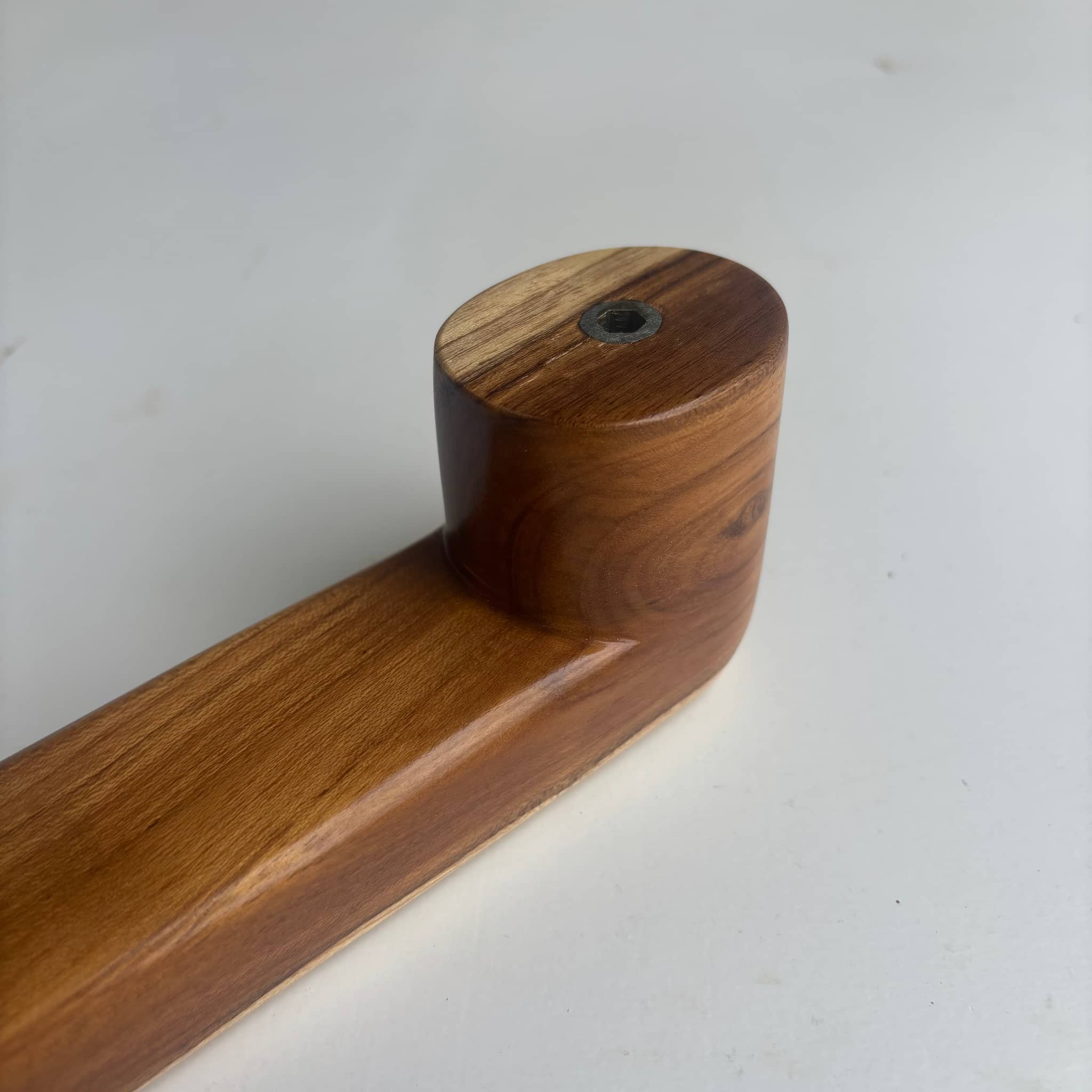 Teak wood door handle with a natural finish for modern interiors