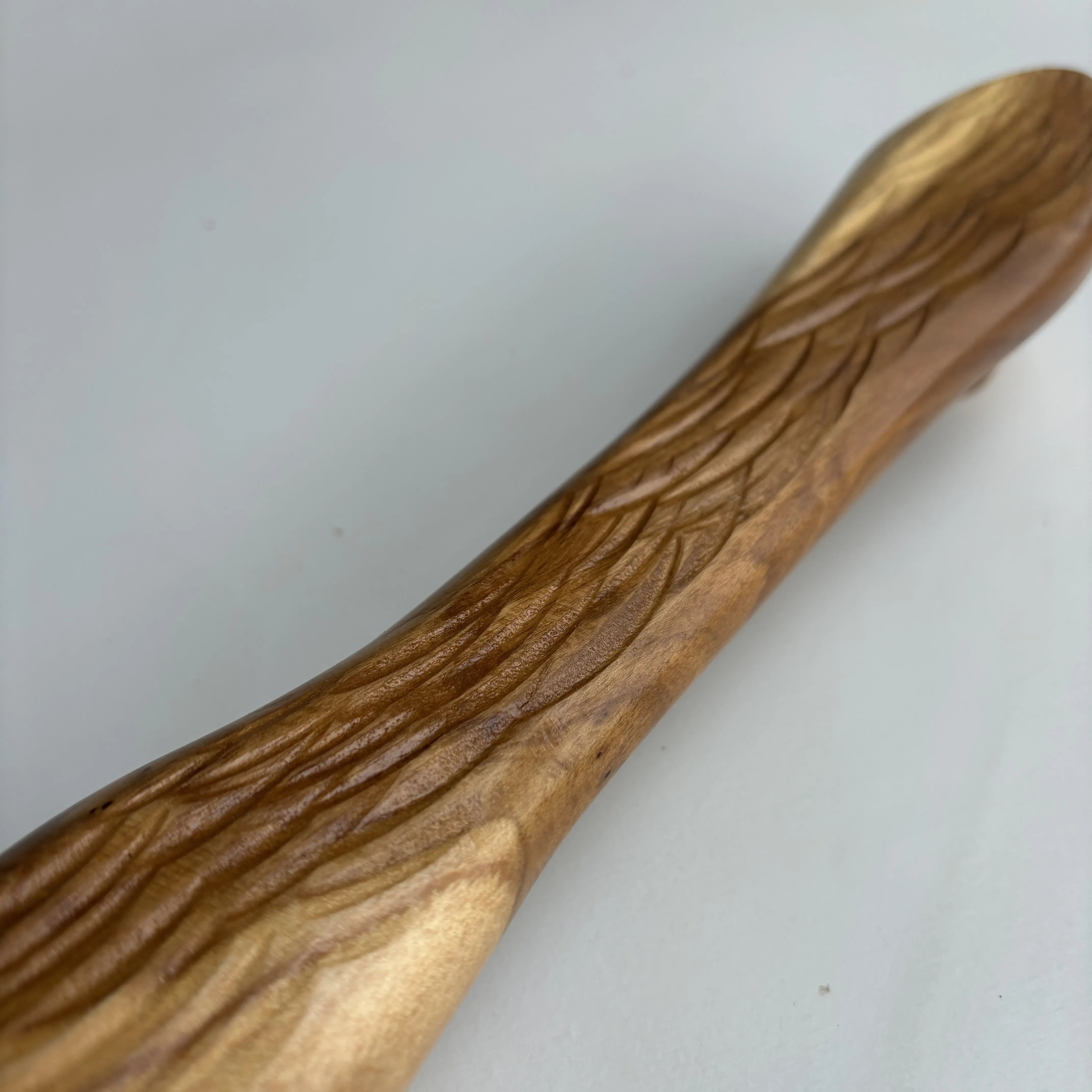 Teak wood drawer pull with an intricate carved design