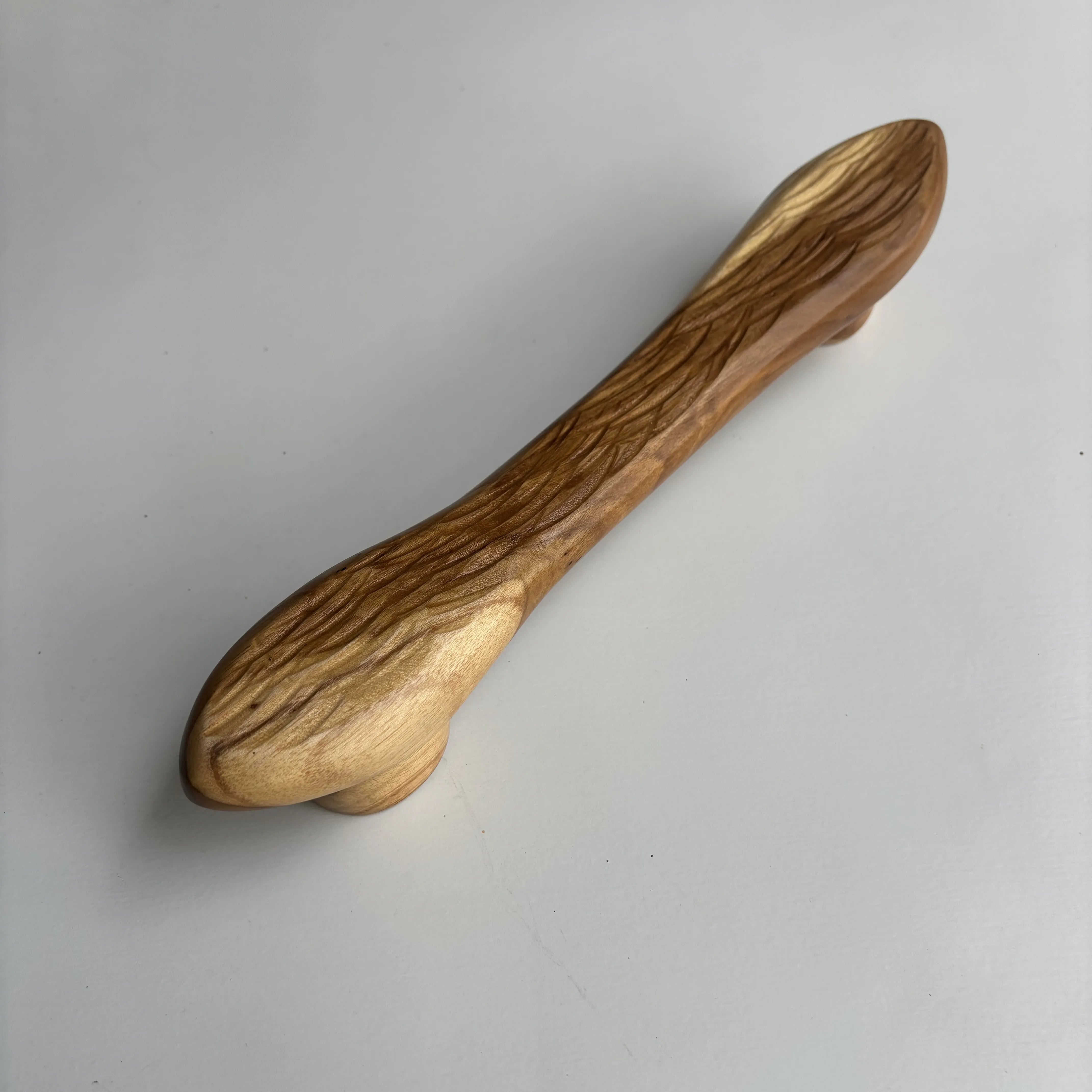 Teak drawer pull with a natural finish for cabinets