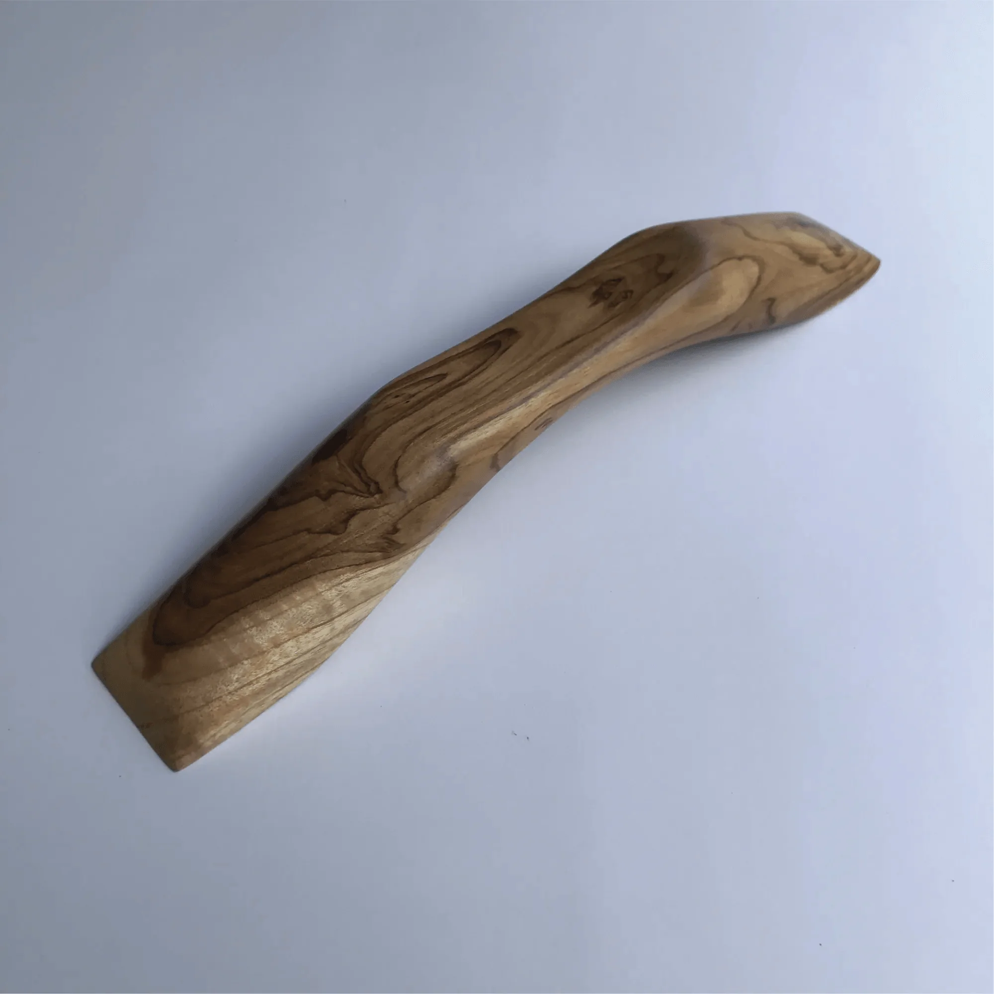 Elegant wood drawer pull crafted from Ceylon wood with a smooth, curved design