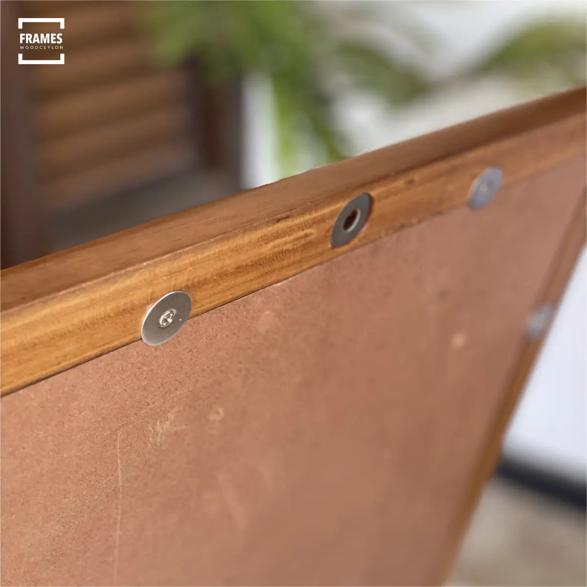 Close-up of a Wooden Ceylon picture frame showing sturdy backing and metal clips for secure display