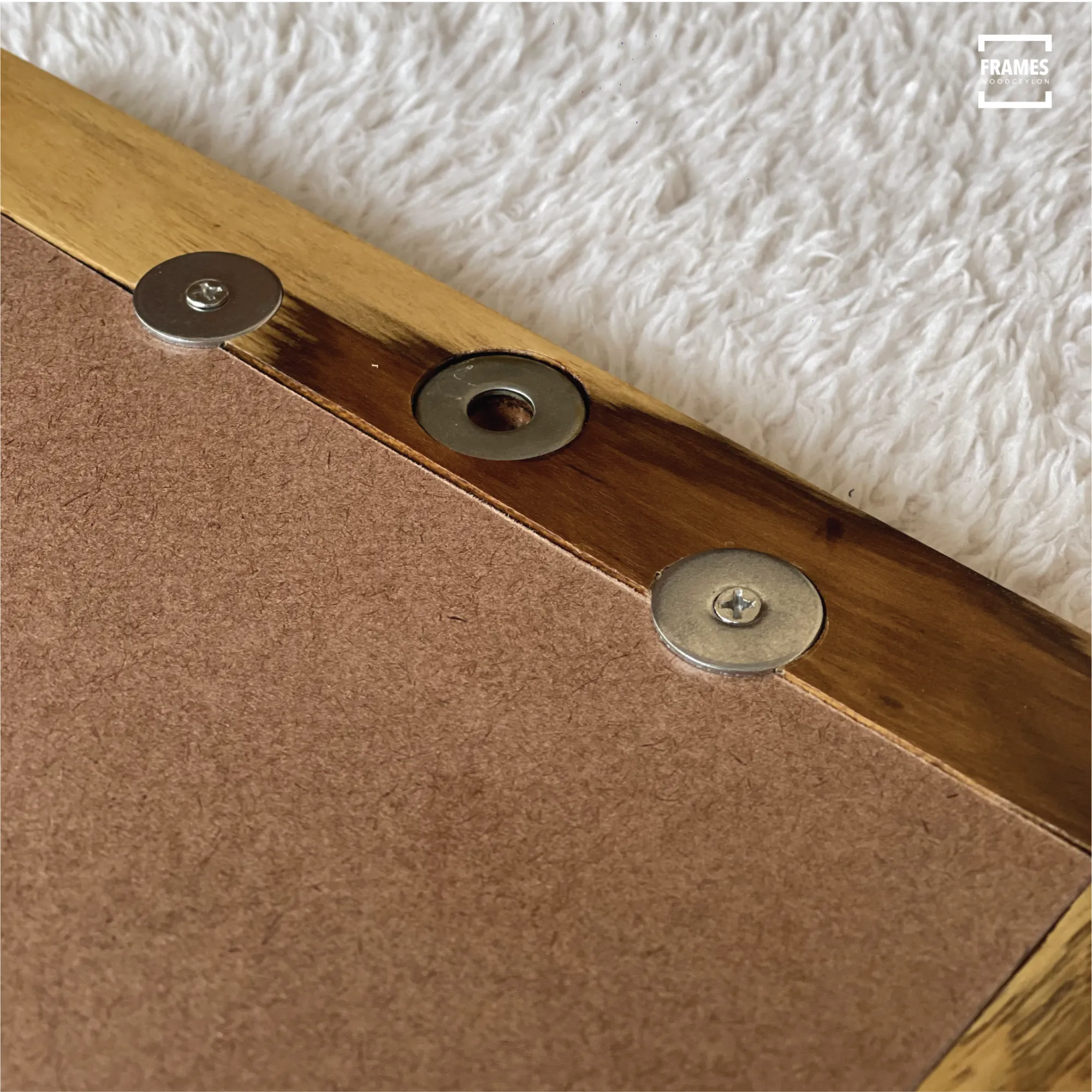 Close-up of Wood Ceylon wooden picture frame corner showing metal screws and back panel