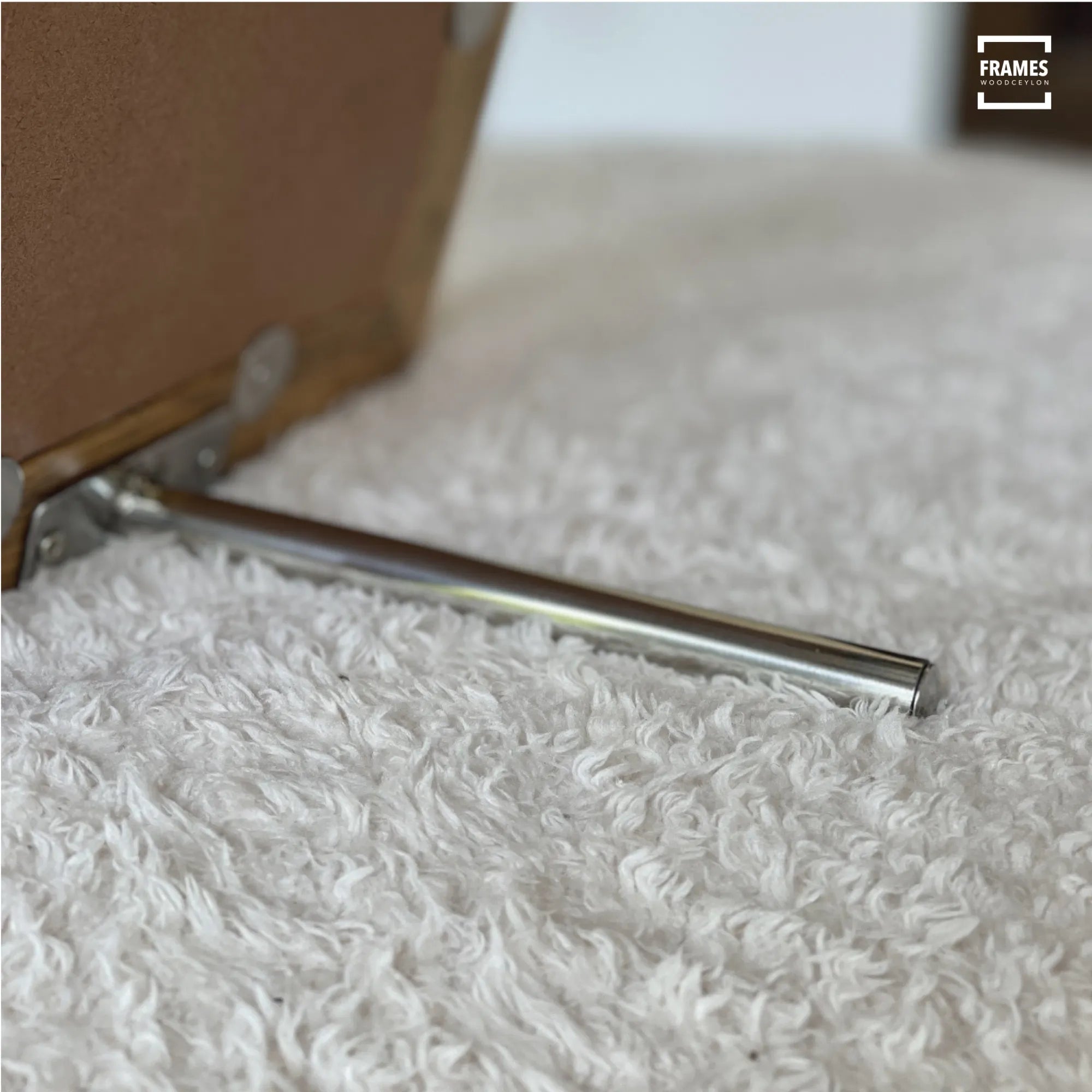 Close-up of metal stand support on the back of a wooden picture frame by Wood Ceylon