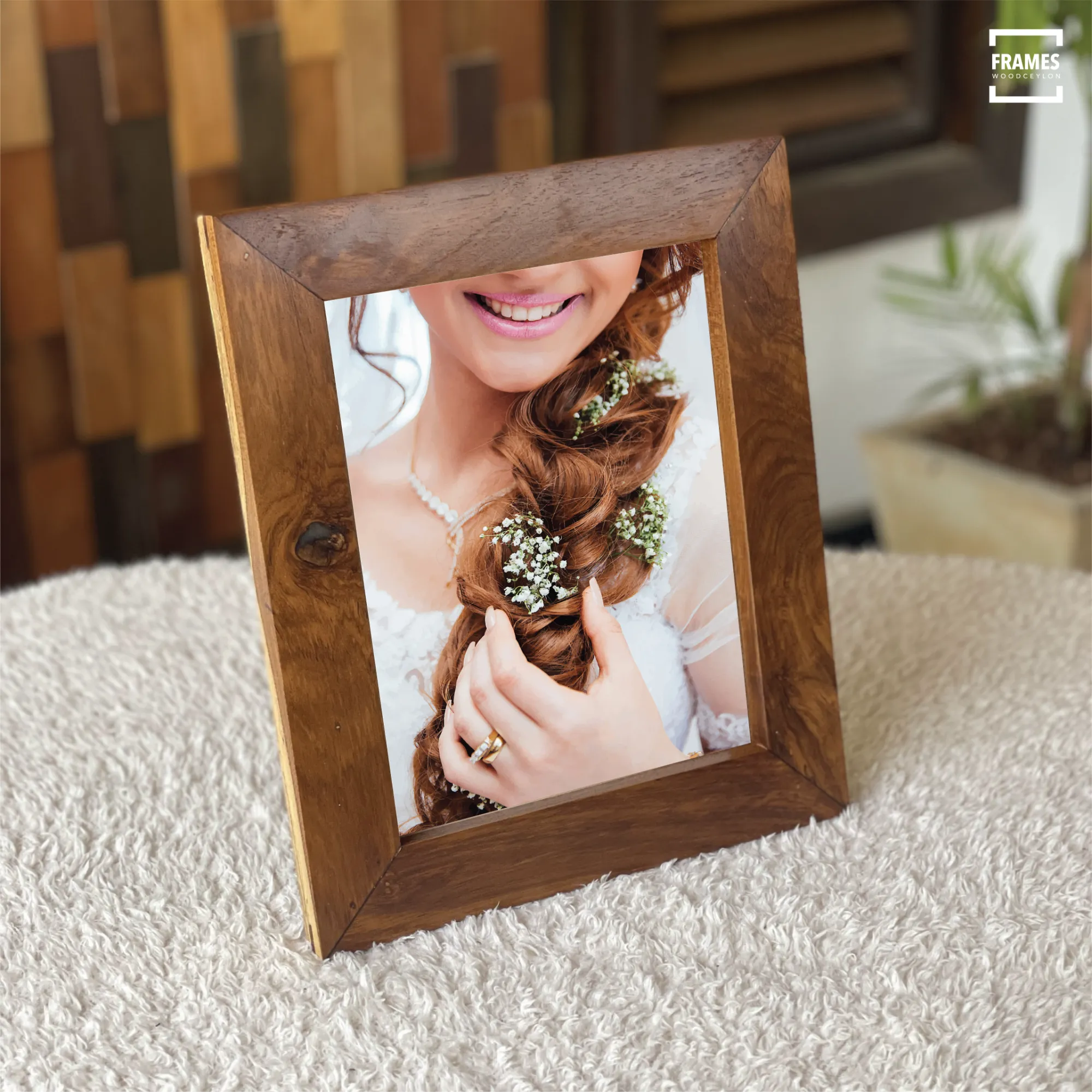 Wooden picture frame by Wood Ceylon showcasing a rustic dark wood finish on a textured surface