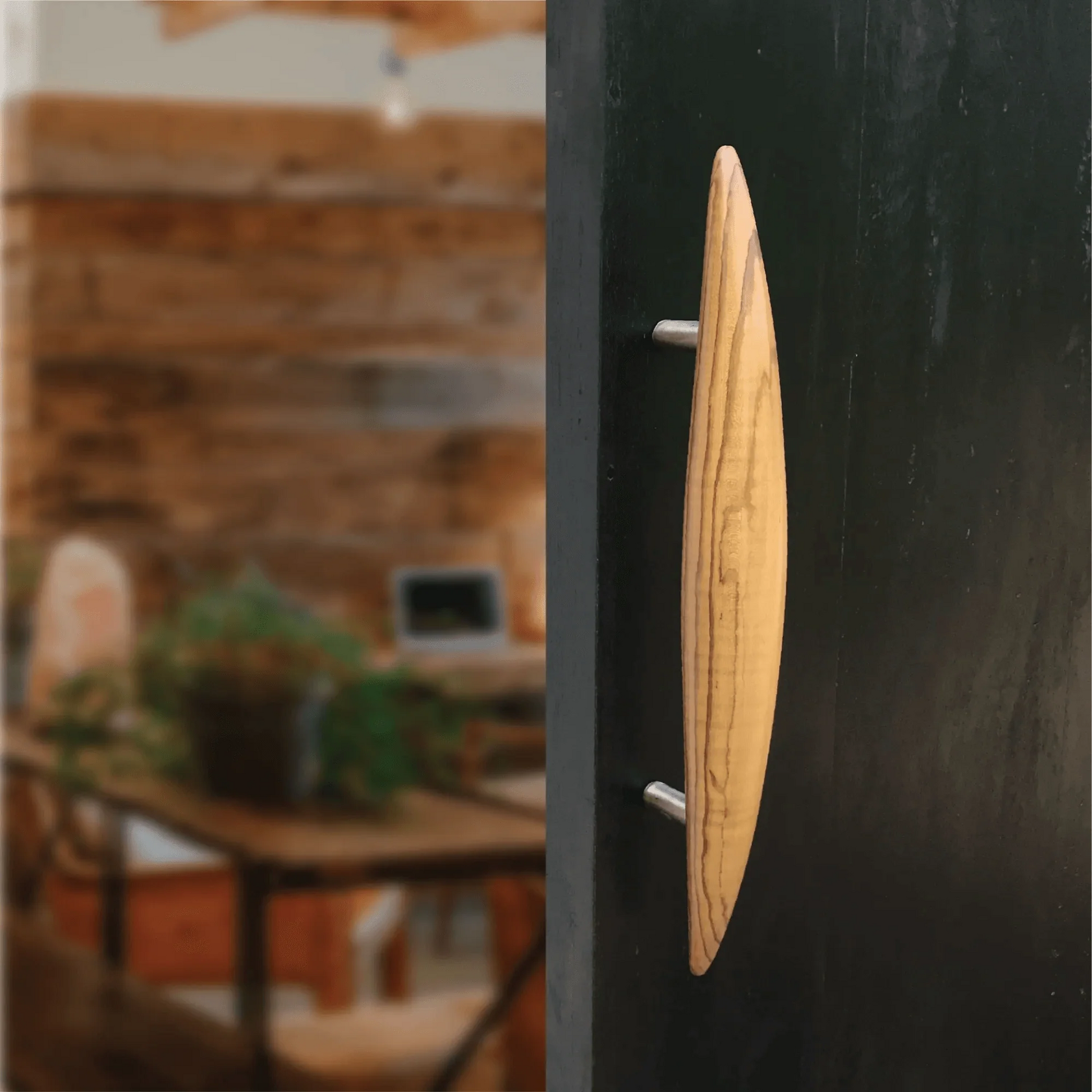Elegant wooden front door handle with a sleek design suitable for modern entrances
