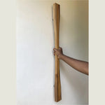 Large front door handle made of wood, featuring a sleek design for modern entryways