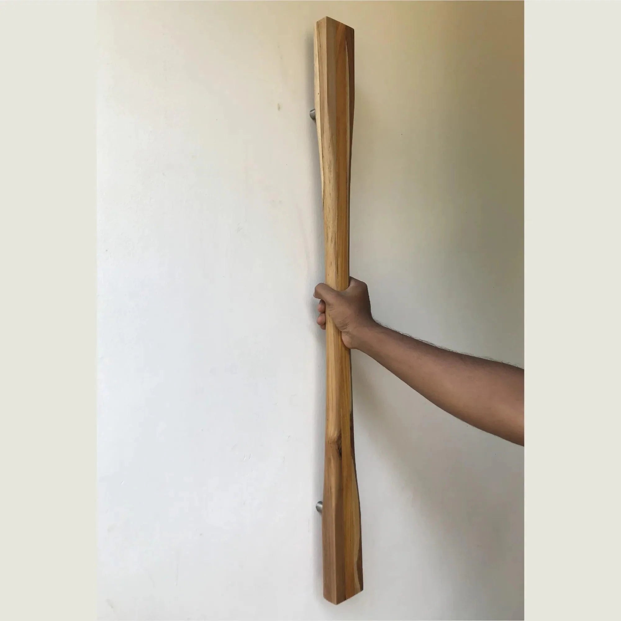 Large front door handle made of wood, featuring a sleek design for modern entryways