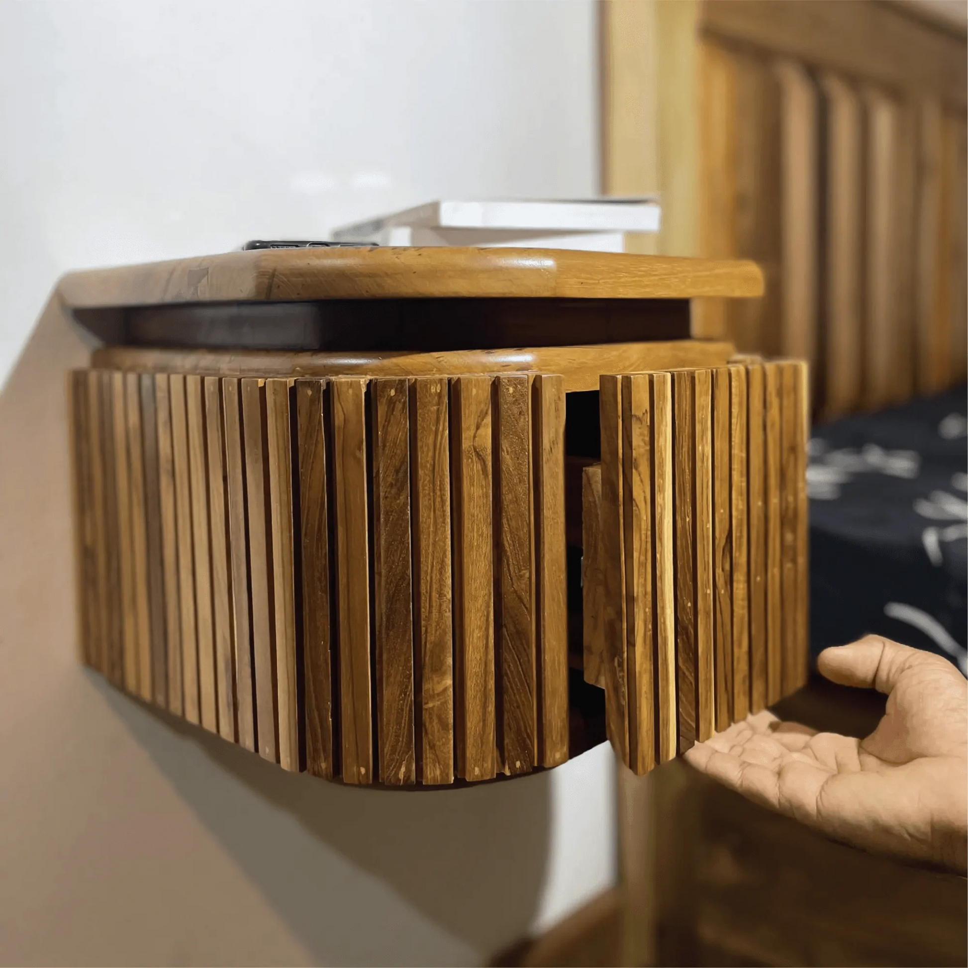 Wood Ceylon wooden floating nightstand with drawer mounted on wall showing open door