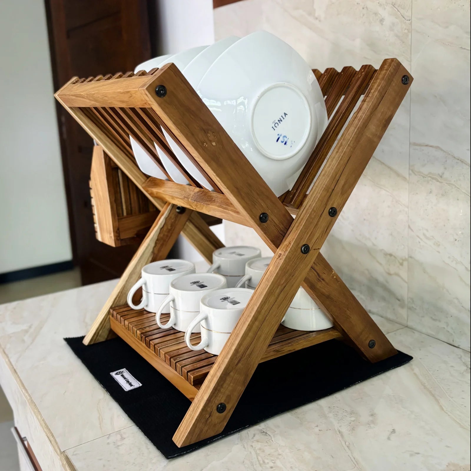 Wood Ceylon small dish drying rack made of wood holding white plates and cups on kitchen counter