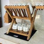 Wood Ceylon small dish drying rack made of natural wood holding white plates and bowls on countertop