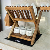 Wood Ceylon small dish drying rack made of natural wood holding white plates and bowls on countertop