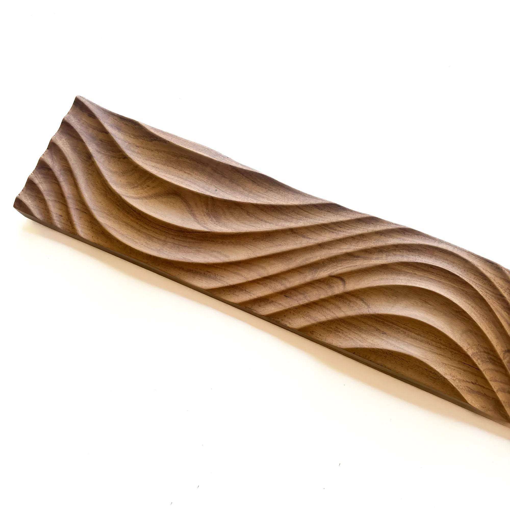 Intricately carved solid teak wood panel with wavy design for decorative use