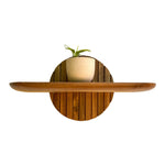 Wood Ceylon teak floating plant shelf with round backplate holding a small potted plant