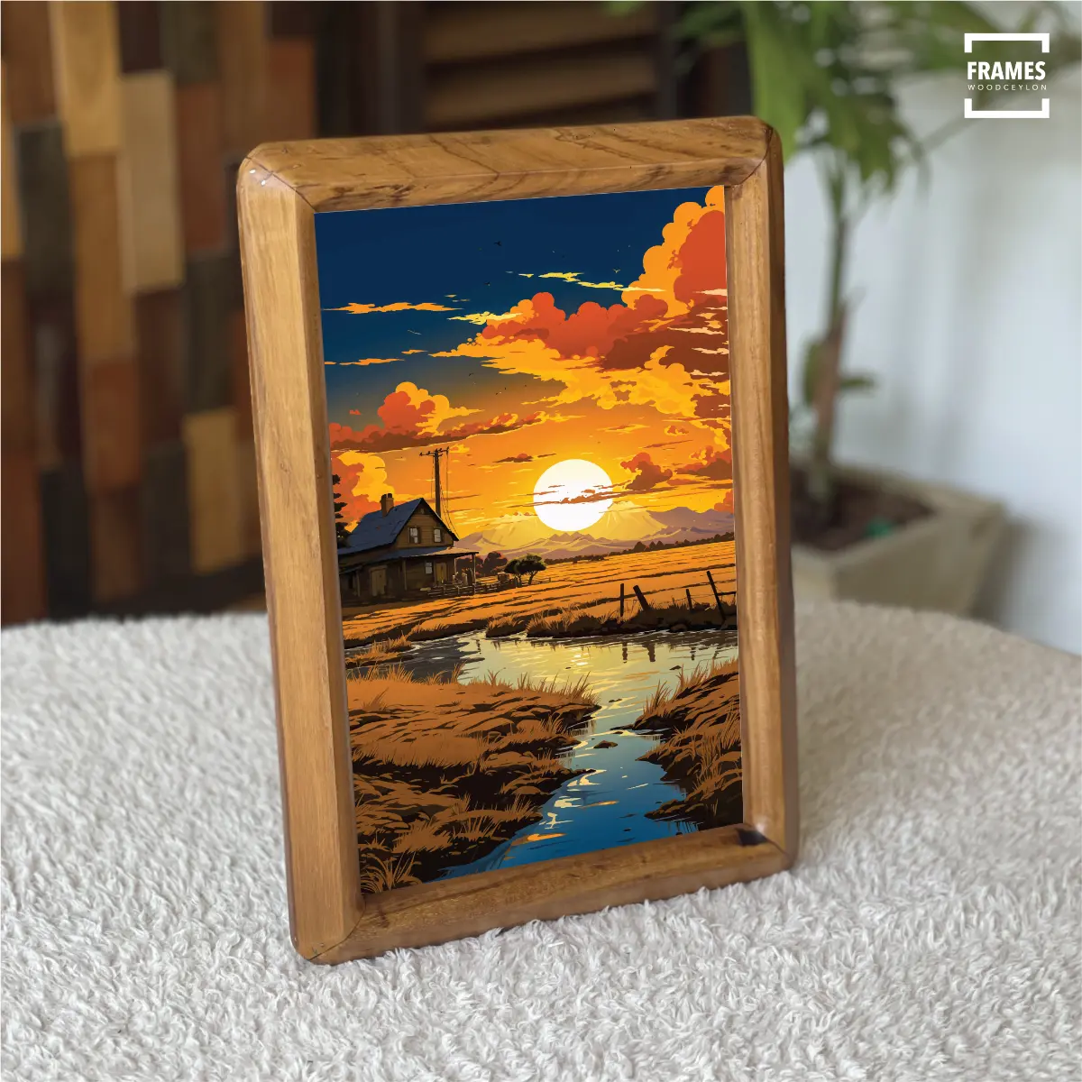 Teak picture frame displaying a vibrant sunset landscape with a river and house
