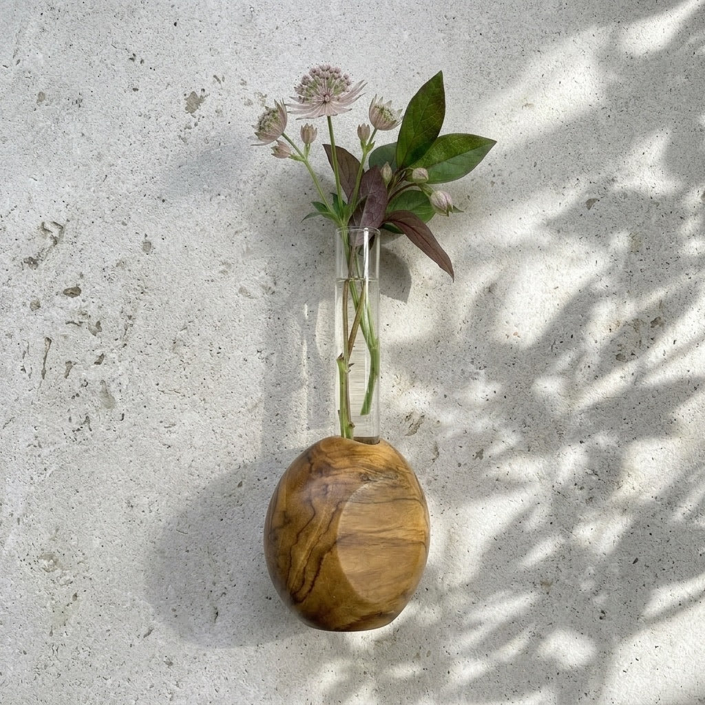 Round Teak Vase showcasing natural wood finish with floral arrangement