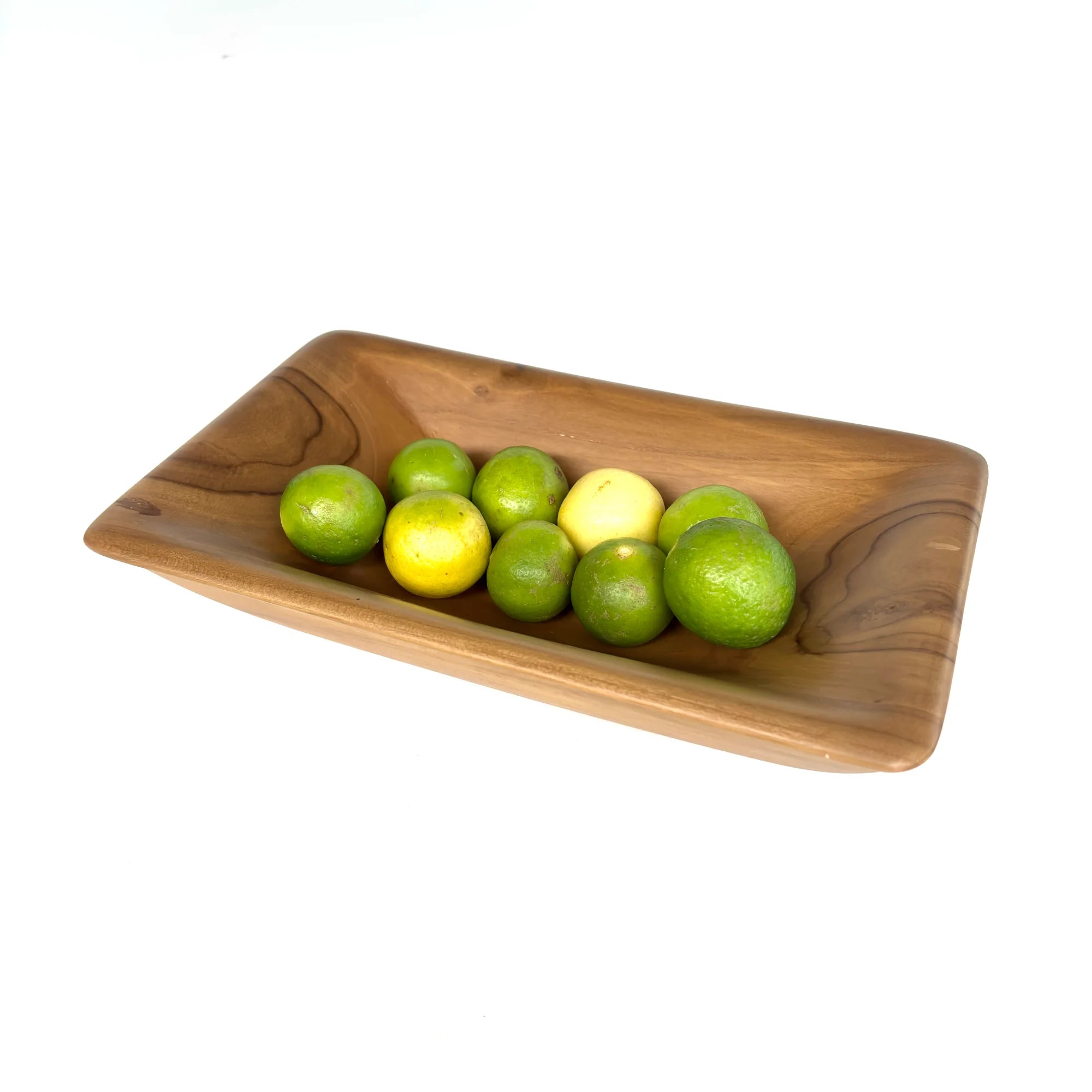 Elegant teak wood serving bowl displaying fresh limes and lemons for a stylish dining experience