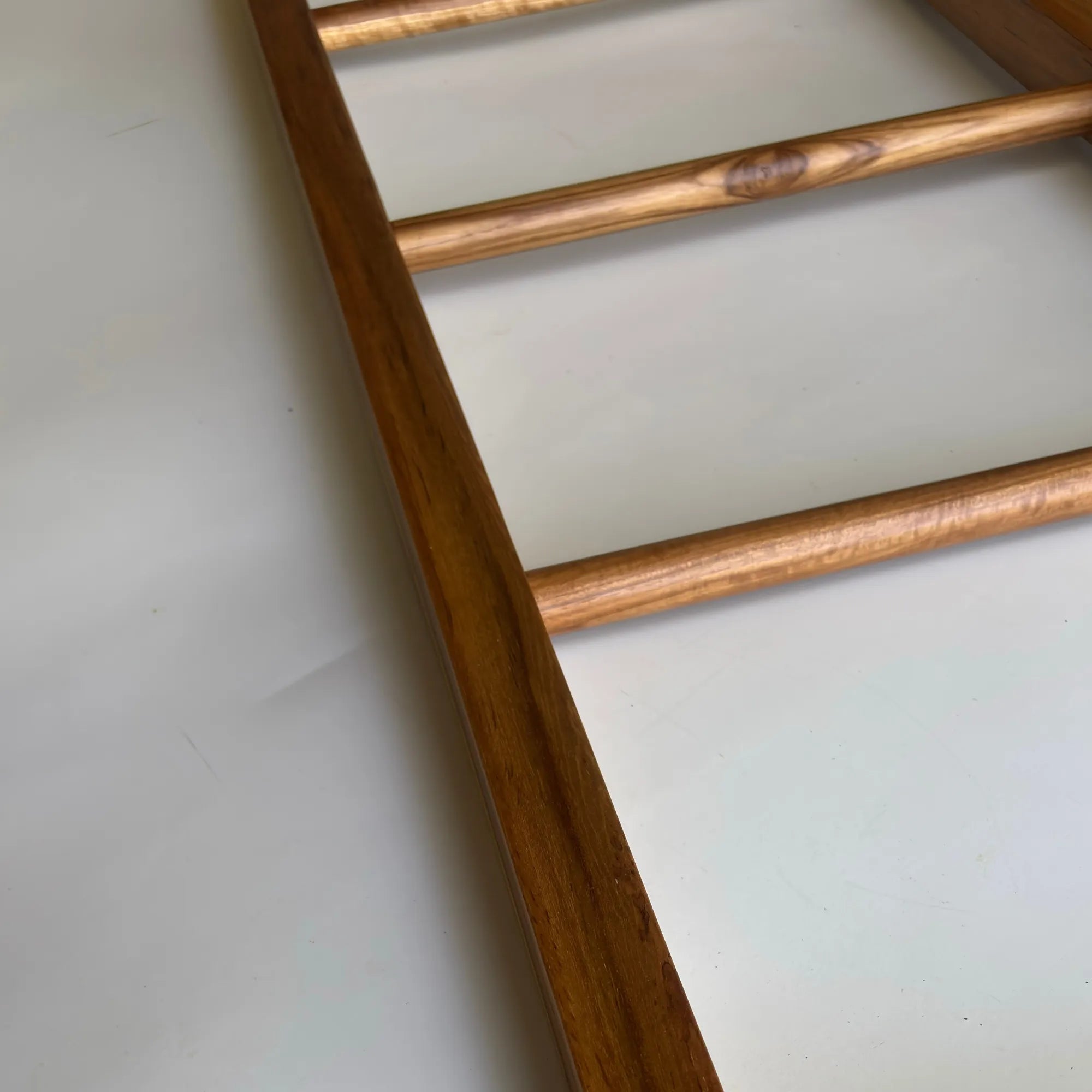 Teak towel ladder rack in natural wood finish for stylish bathroom storage