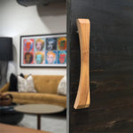 Wood Ceylon natural wooden sliding door handle mounted on dark sliding door in modern living room
