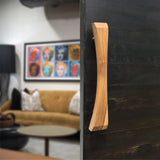 Wood Ceylon natural wooden sliding door handle mounted on dark sliding door in modern living room