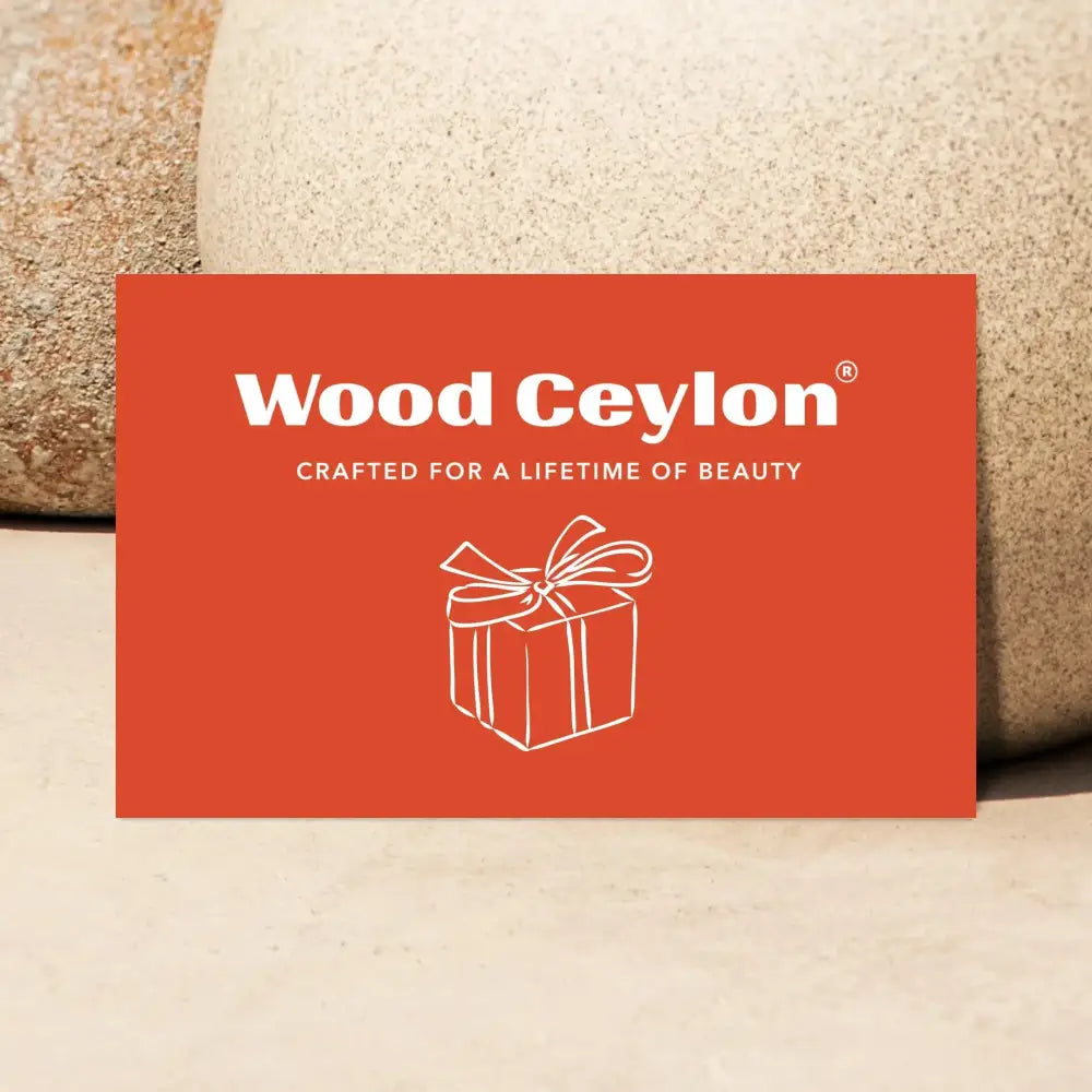 Wood Ceylon gift card in burnt orange with white text and gift box illustration on natural stone background
