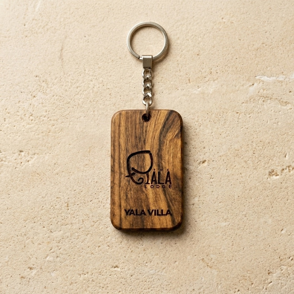 Personalized solid teak wood key tag with engraved lodge logo and metal key ring, custom engraving example