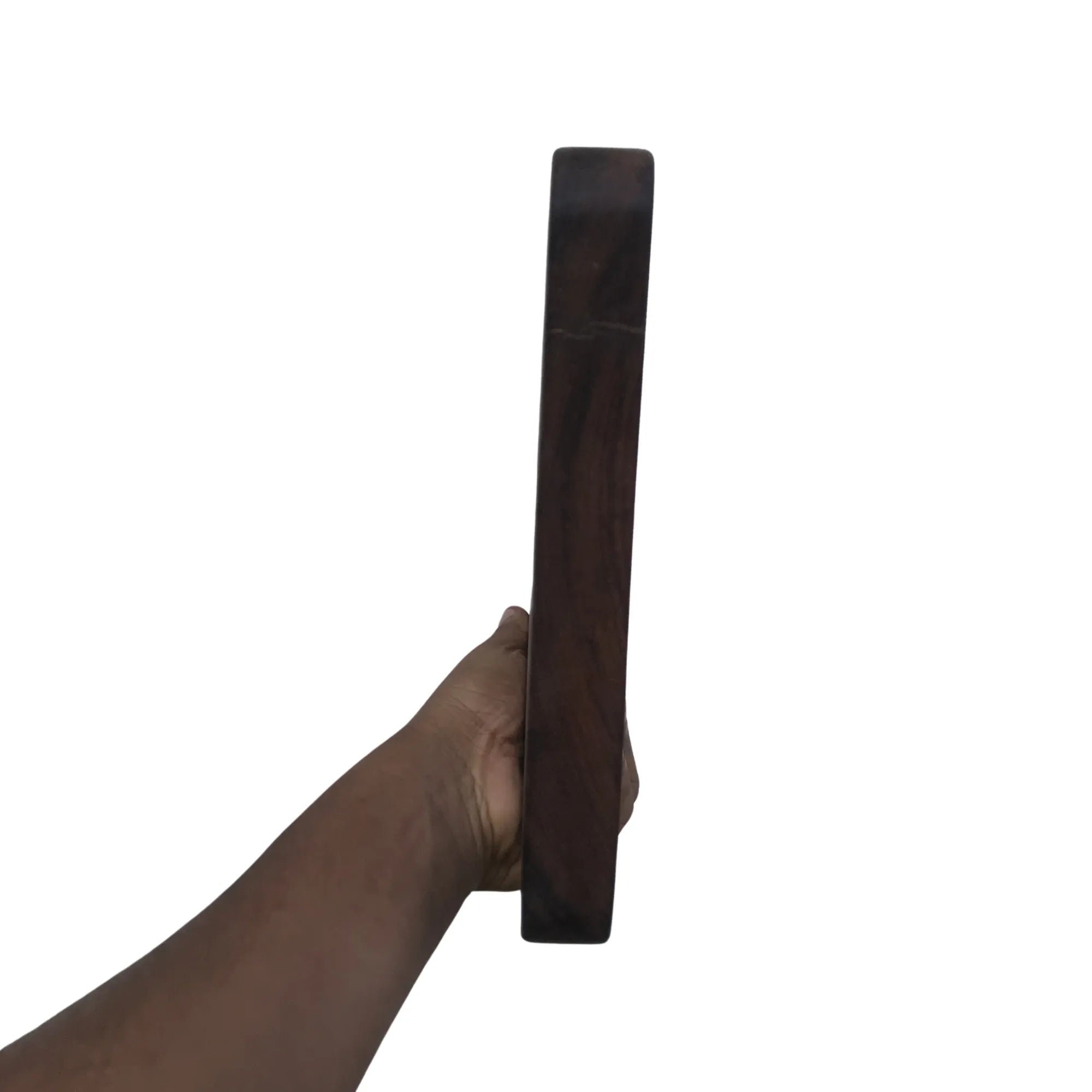 Hand holding a thick dark wood cutting board by Wood Ceylon showing side profile