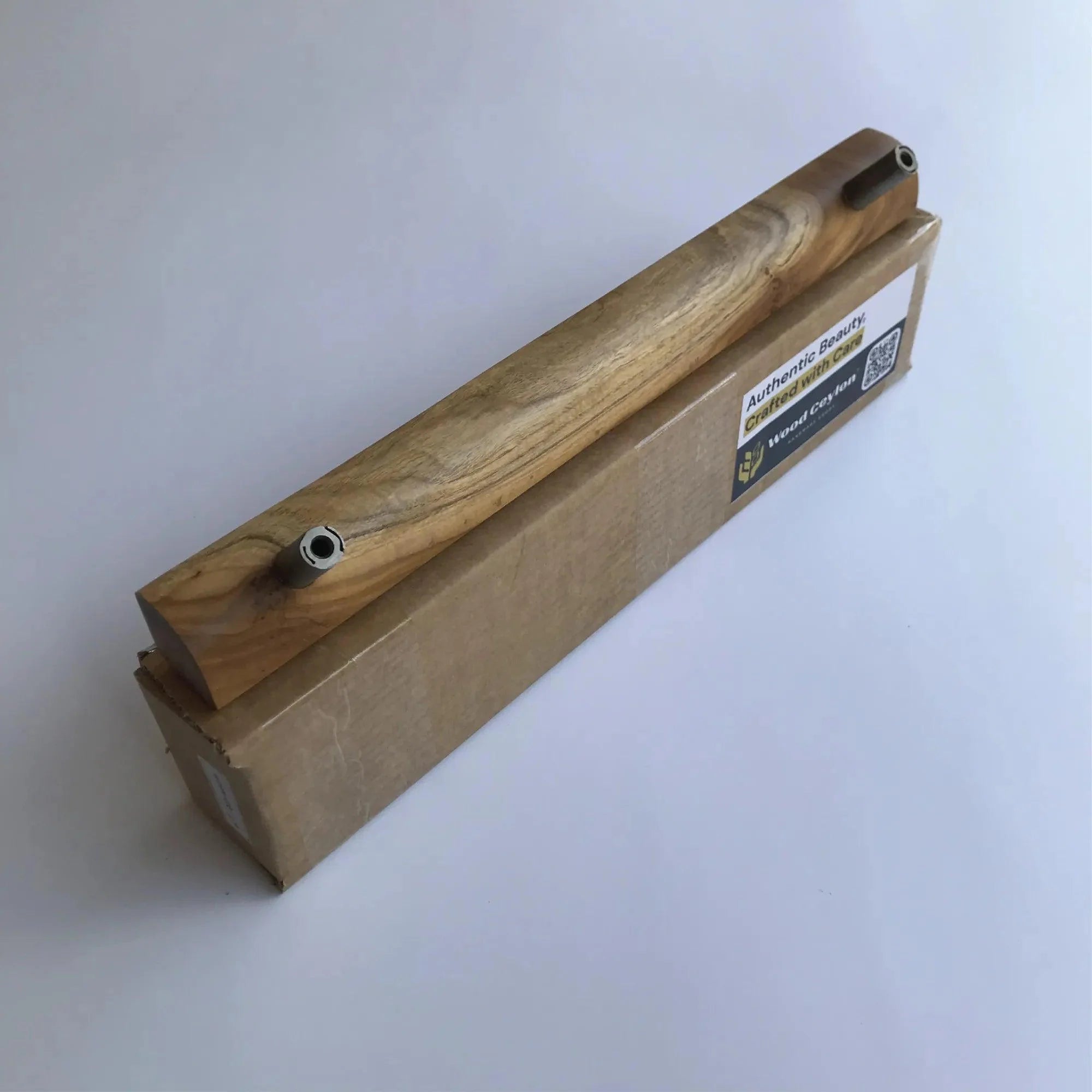 Wood Storm Door Handle by Wood Ceylon displayed on a cardboard box showcasing natural wood grain