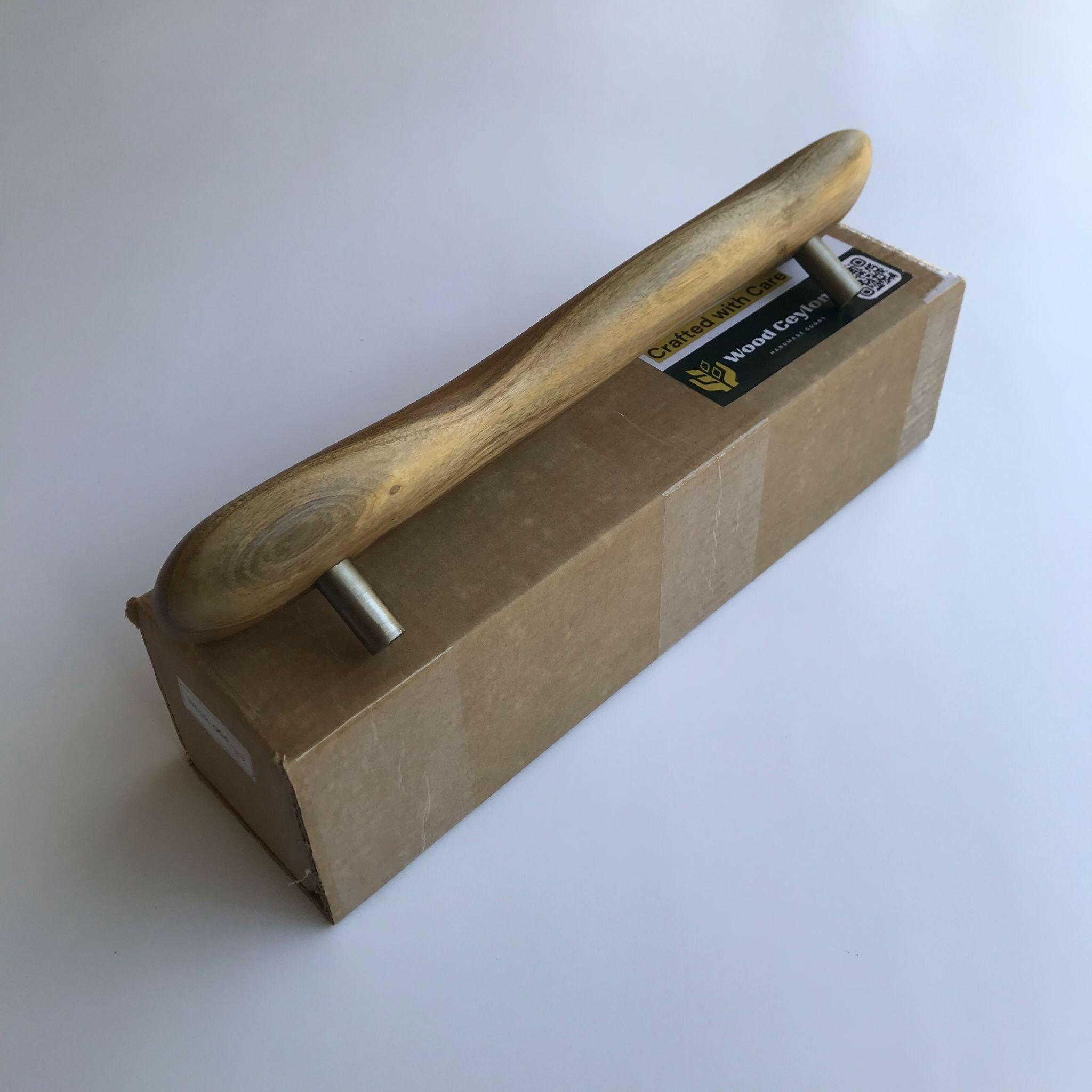 Wood Ceylon handcrafted wooden door handle with metal mounting on a cardboard box
