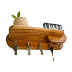 Elegant wooden key holder with shelf featuring hooks for keys and a small planter for decor