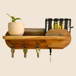 Wooden key holder with shelf featuring hooks and a plant pot for stylish organization
