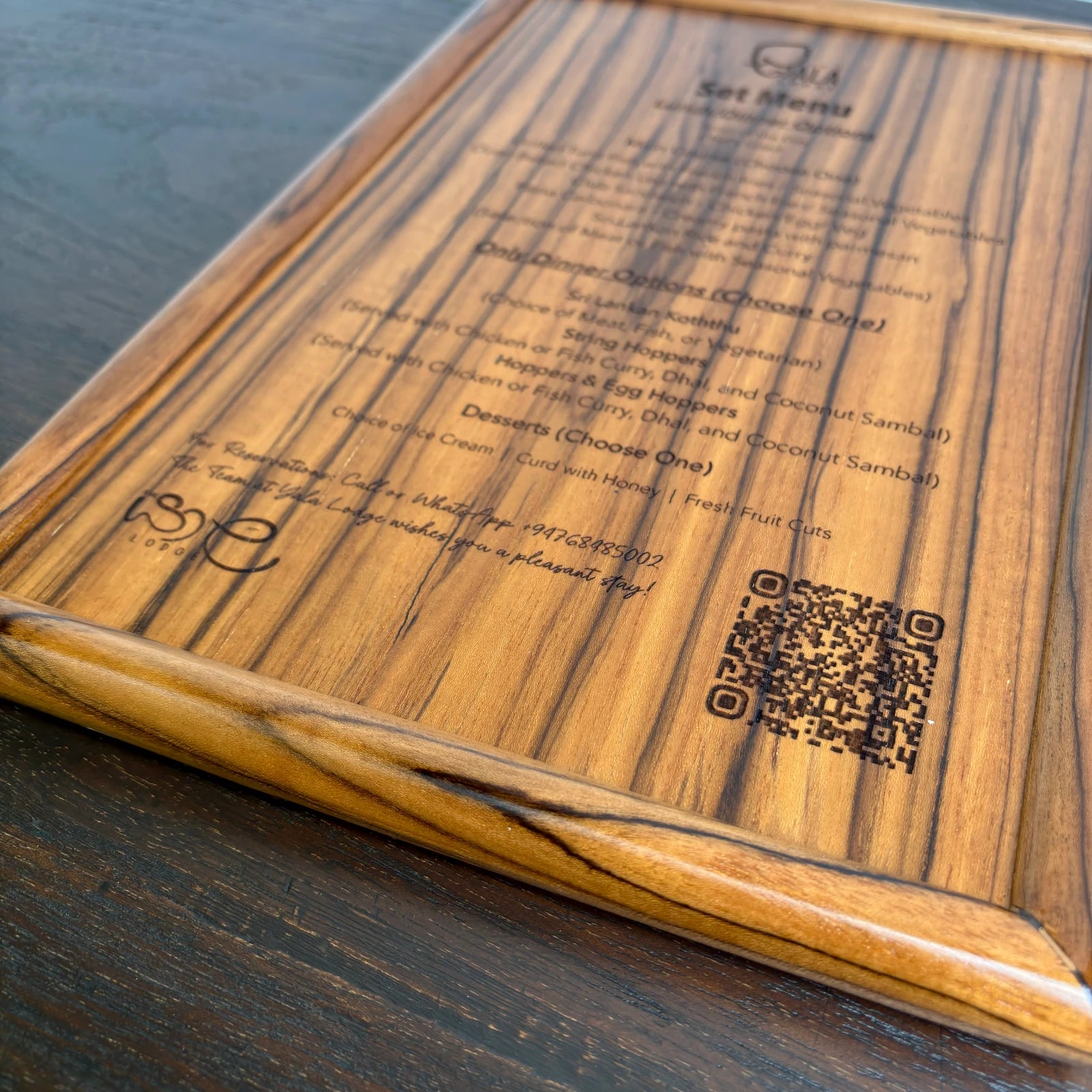 Wood Ceylon laser engraved menu card with detailed food options and QR code on wooden surface
