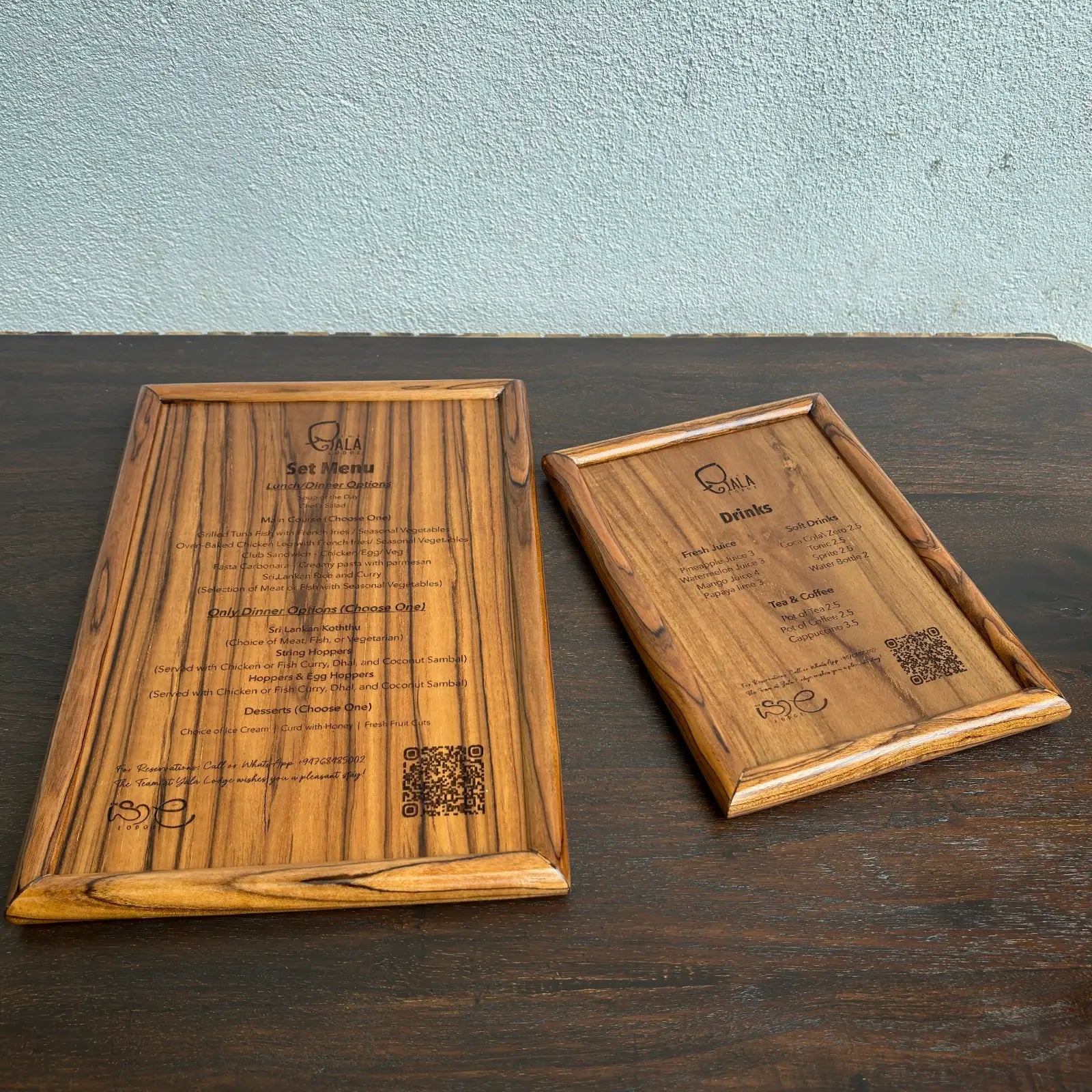 Two wooden menu boards made of teak, showcasing drink and food options.