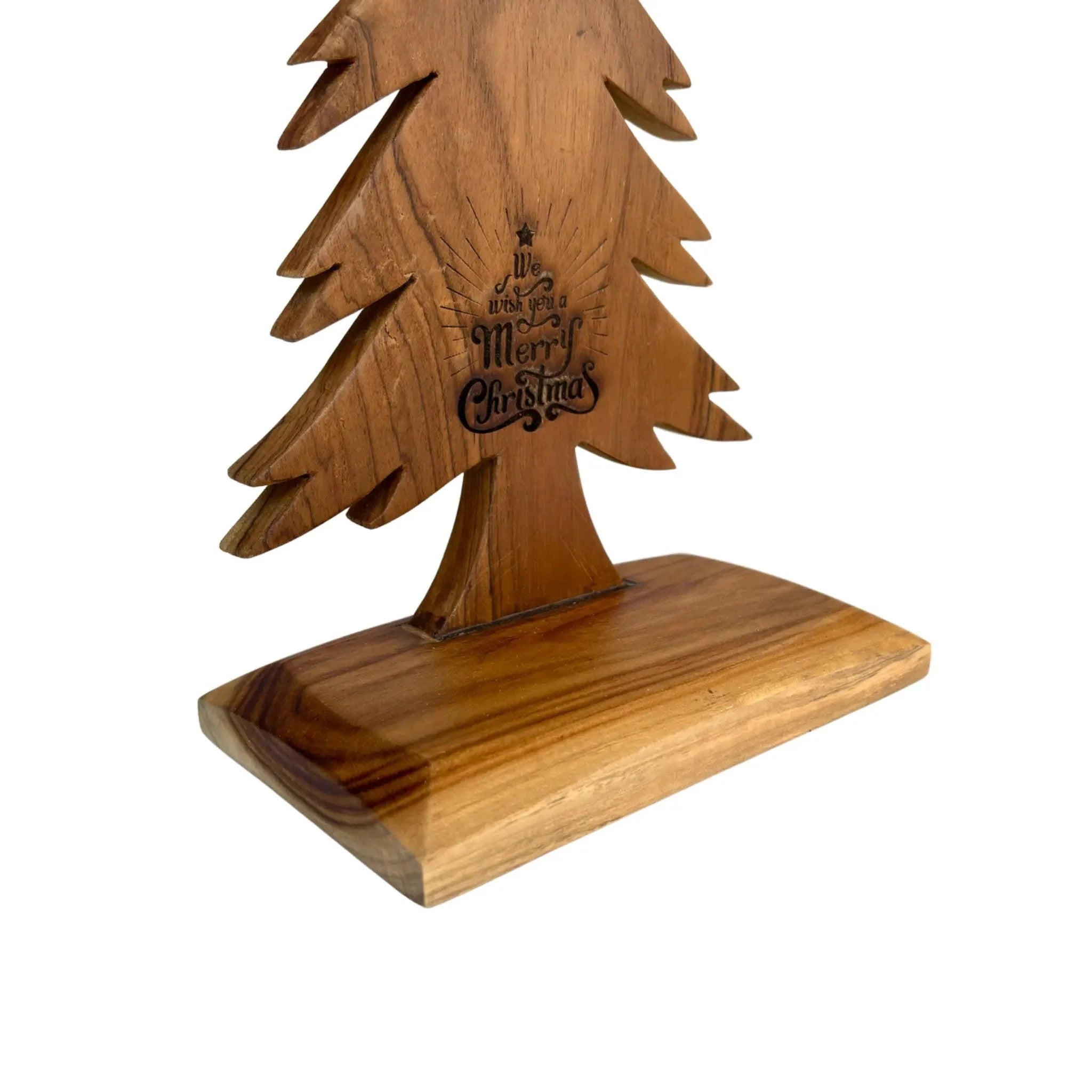 Wooden tabletop Christmas tree with engraved Merry Christmas design on natural wood base
