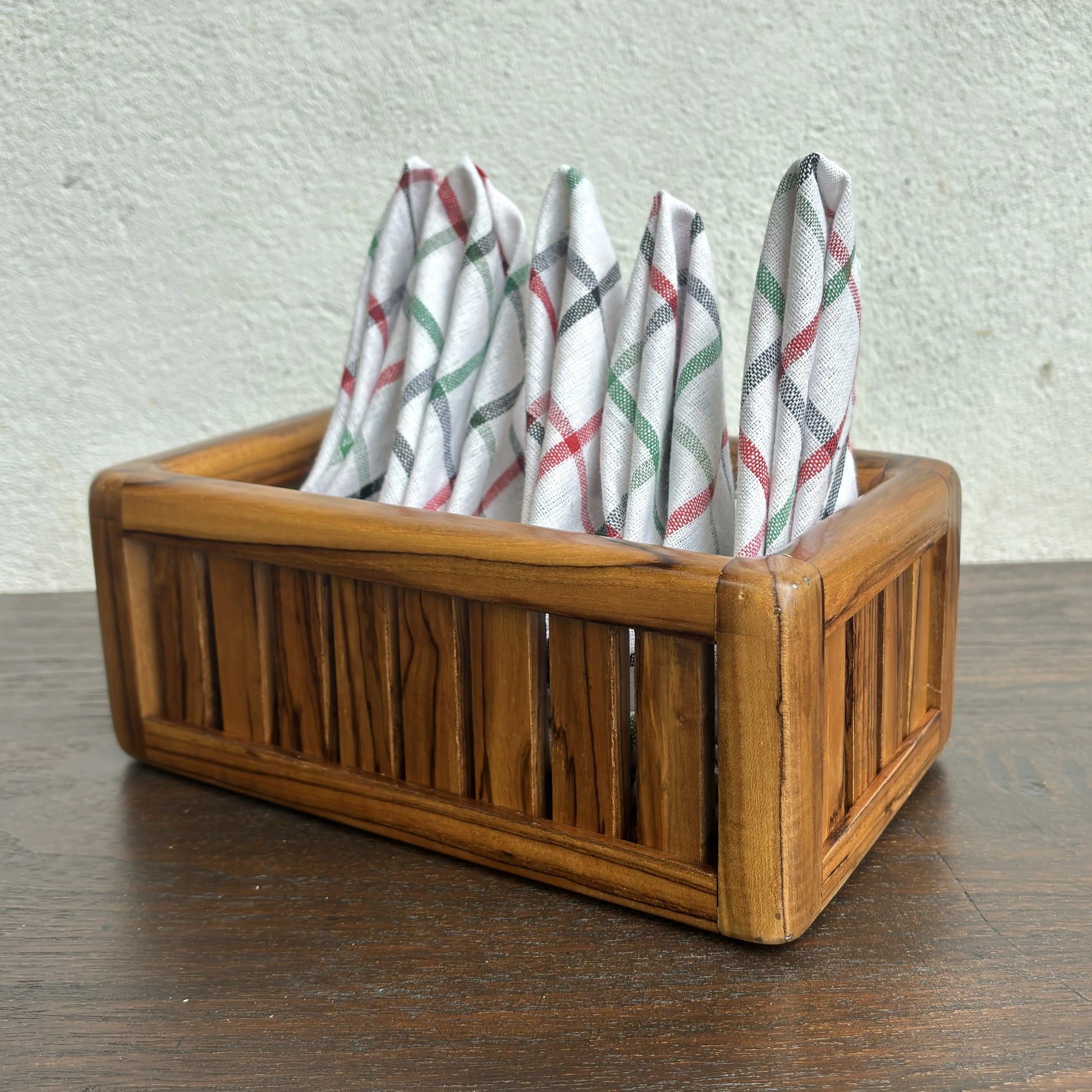 Wood Ceylon wooden towel box storage with vertical slats and folded patterned towels inside